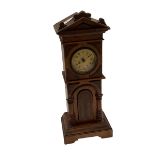 A miniature long case clock