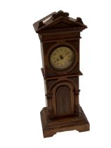 A miniature long case clock