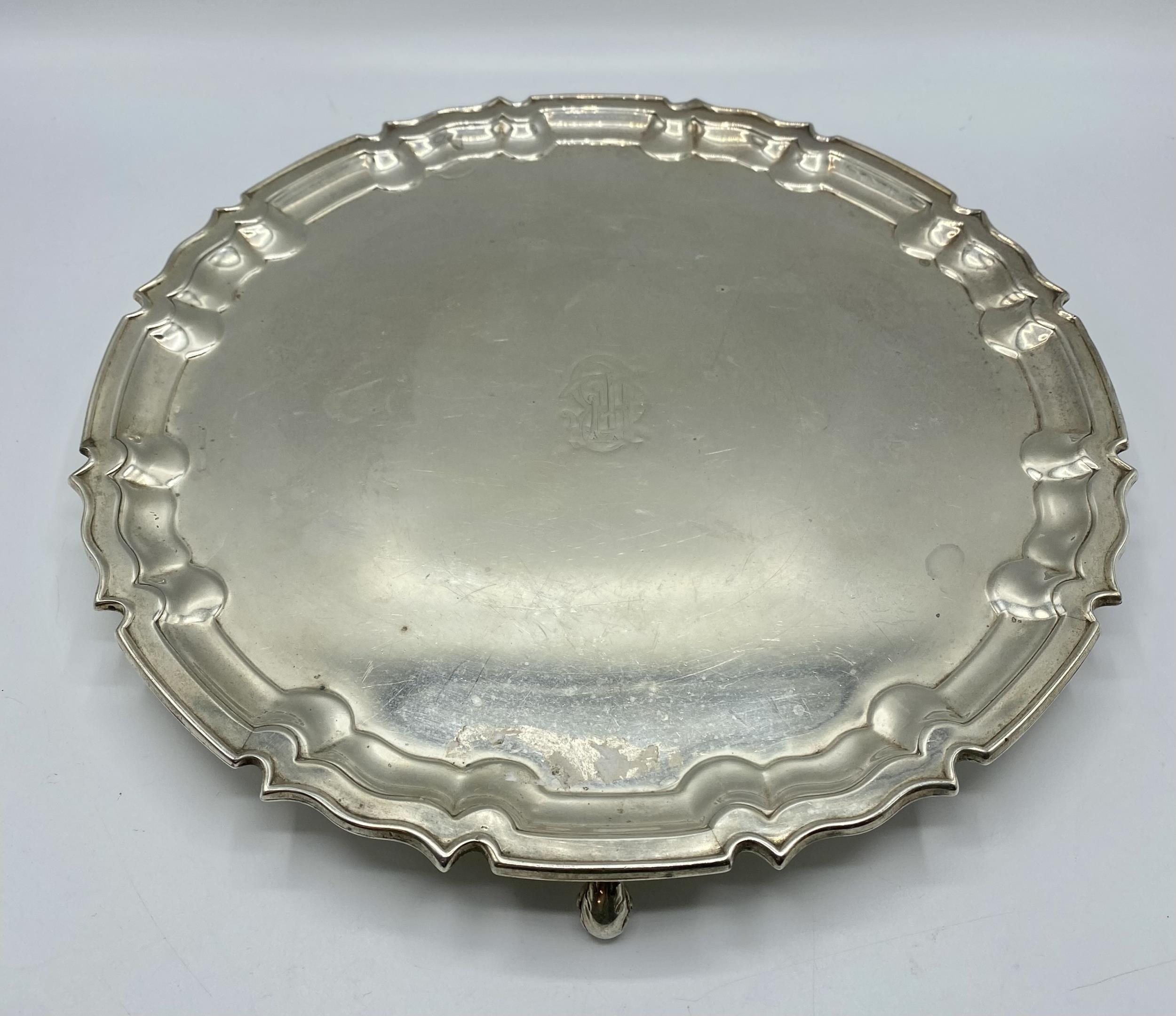 A sterling silver circular tray on three scroll feet by William Hutton and Sons Ltd, Sheffield 1922. - Image 2 of 10