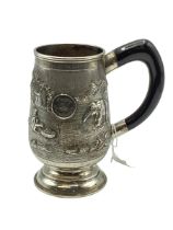 A South Asian white metal mug with country scenes and elephants. Engraved from 'The Calcutta Lodge'.