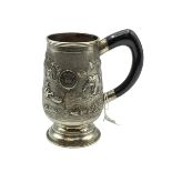 A South Asian white metal mug with country scenes and elephants. Engraved from 'The Calcutta Lodge'.