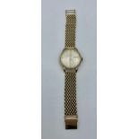 A 9ct gold cased Smiths automatic wristwatch on a 9ct gold bracelet strap. . Champagne dial with