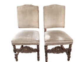 A pair of carved walnut high backed upholstered side chairs, the green fabric in need of re-