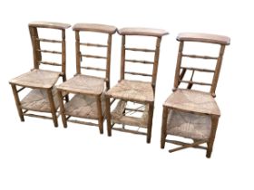 Four French Beech and rush seated Prie Dieu chairs, caning in need of restoration in parts