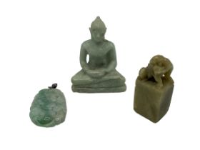 A carved jade pendant together with a small seated buddha and a hardstone seal topped by Fo dog.