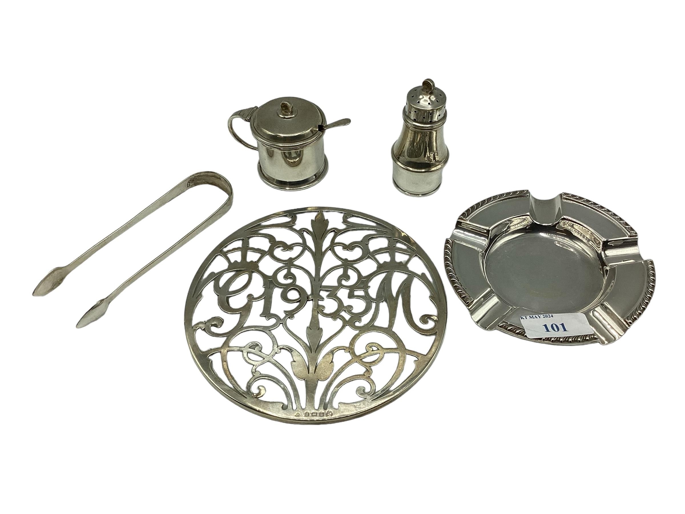 A collection of sterling silver items to include an ashtray and teapot stand, gross weight 560 g