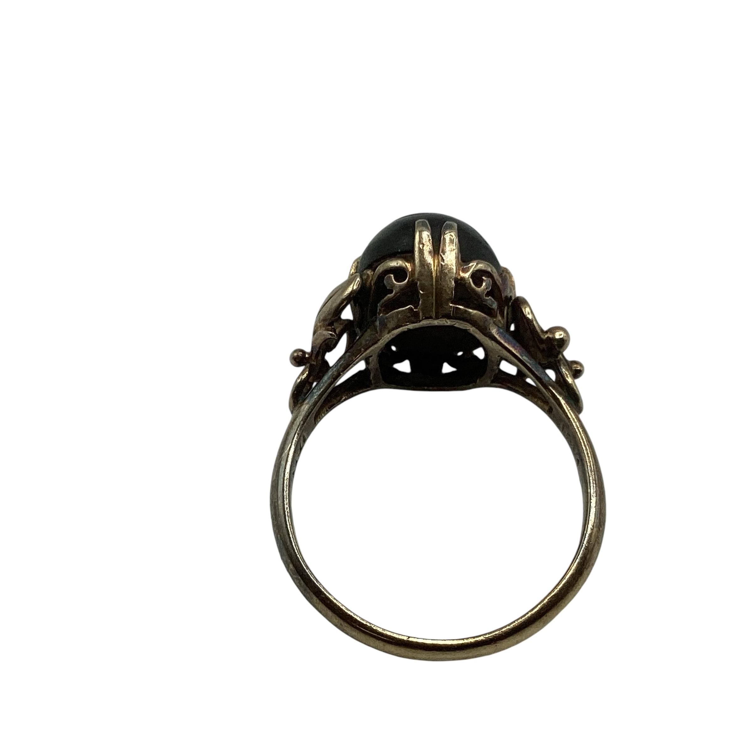 An 18ct gold black star sapphire set ladies dress ring, with scrolling floral shoulders, 4.06 g, - Image 4 of 4