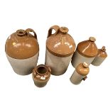 Four flagons, to include one large flagon marked "James Burnet Leith, Portobello Pottery; another