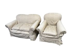 A two seater sofa and chair, upholstered in fawn coloured loose covers