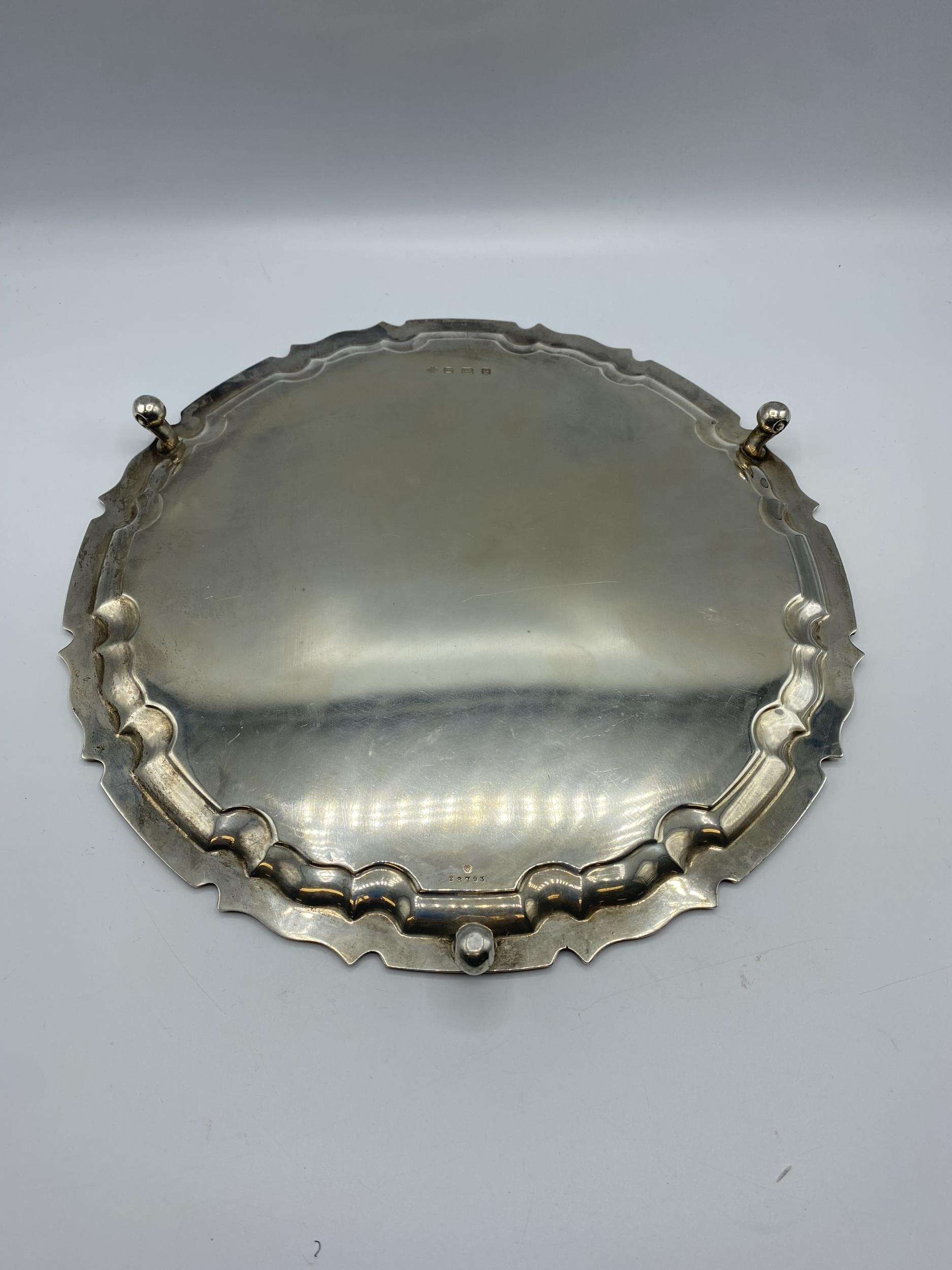 A sterling silver circular tray on three scroll feet by William Hutton and Sons Ltd, Sheffield 1922. - Image 7 of 10