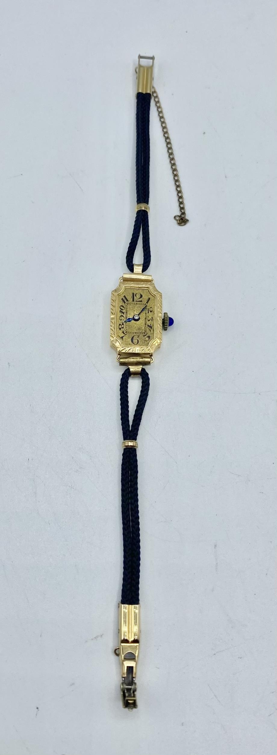 An 18ct gold ladies rectangular cased cocktail watch blue cabochon crown. gold face with roman - Image 2 of 5