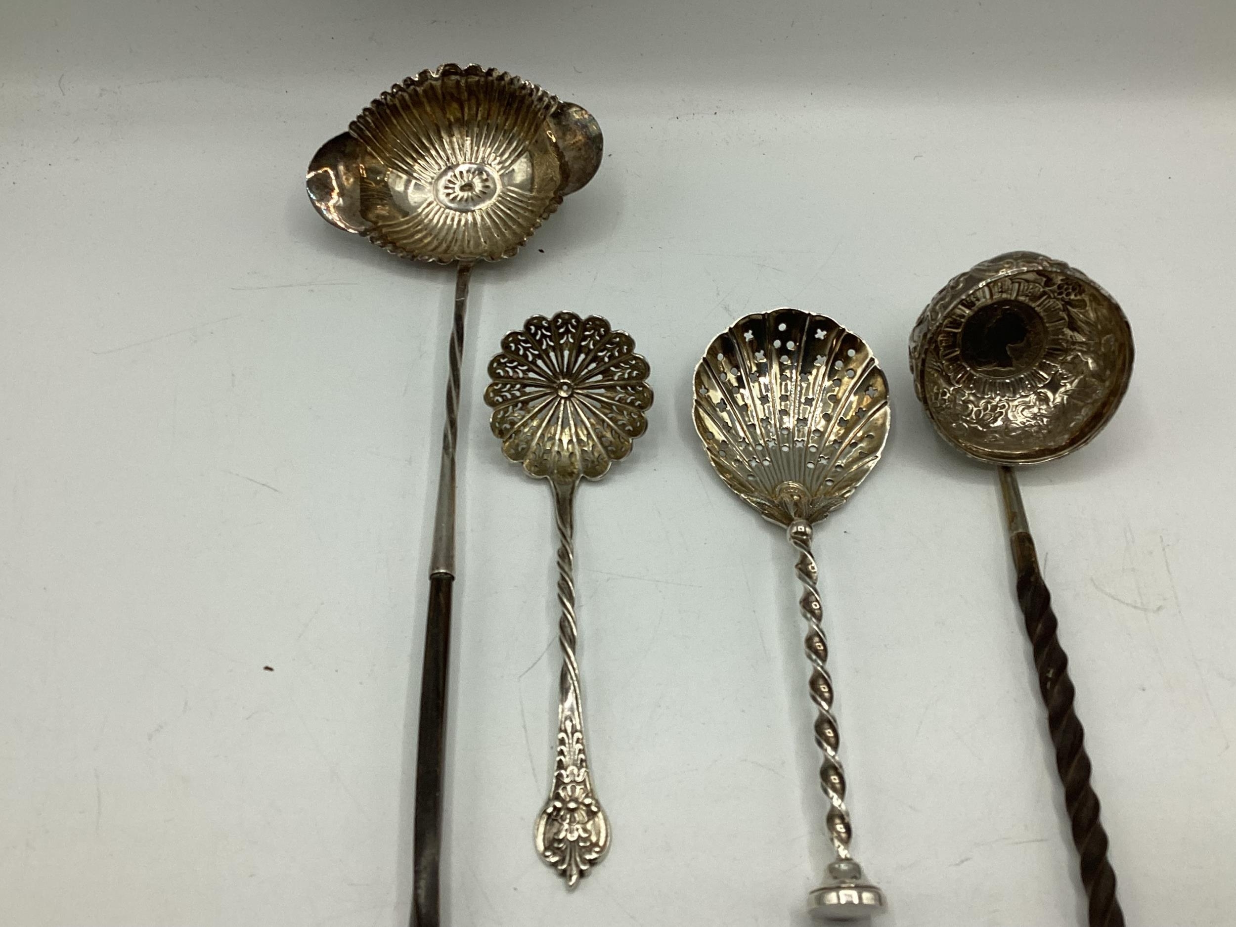 An unmarked white metal coin set toddy ladle with twisted horn/bone handle together with another - Image 2 of 5