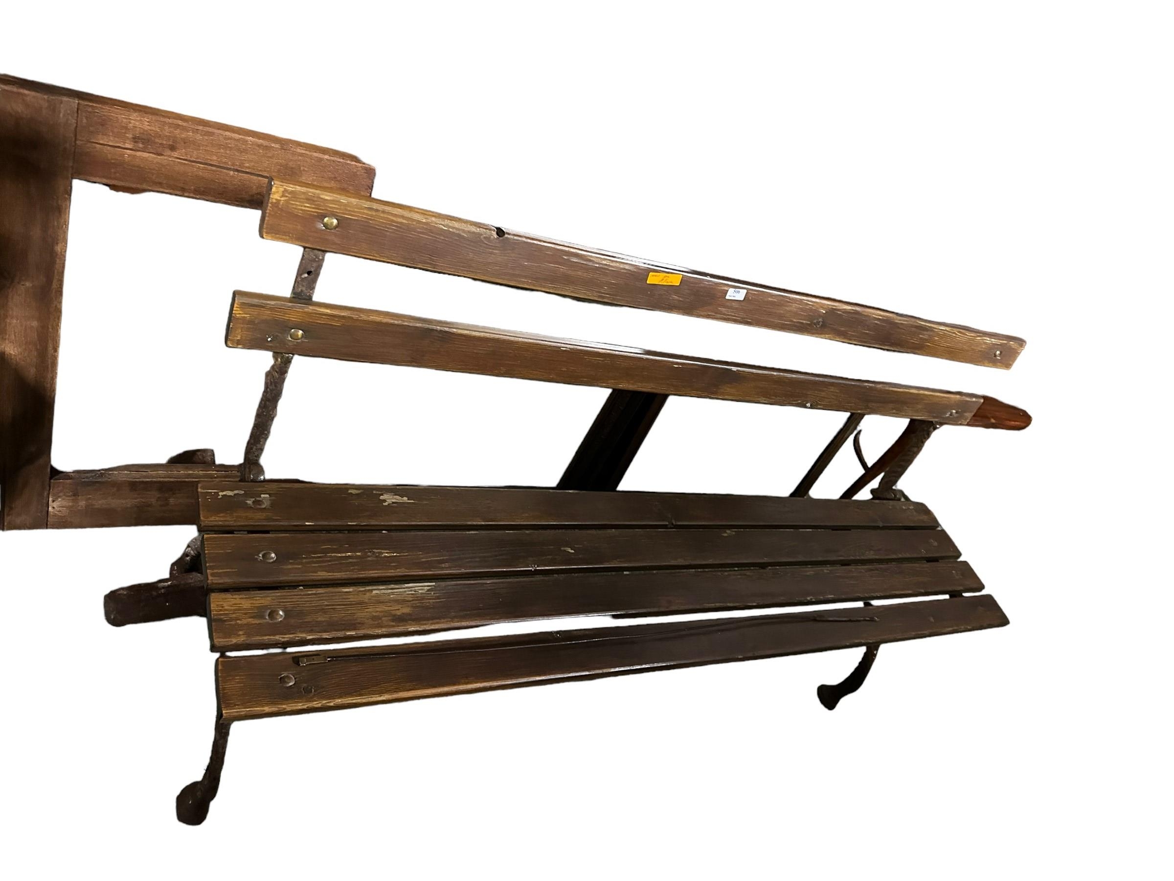 A slatted part wooden bench 151cm L