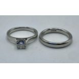 A platinum and single stone diamond ring together with related platinum wedding band. Single