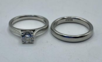 A platinum and single stone diamond ring together with related platinum wedding band. Single