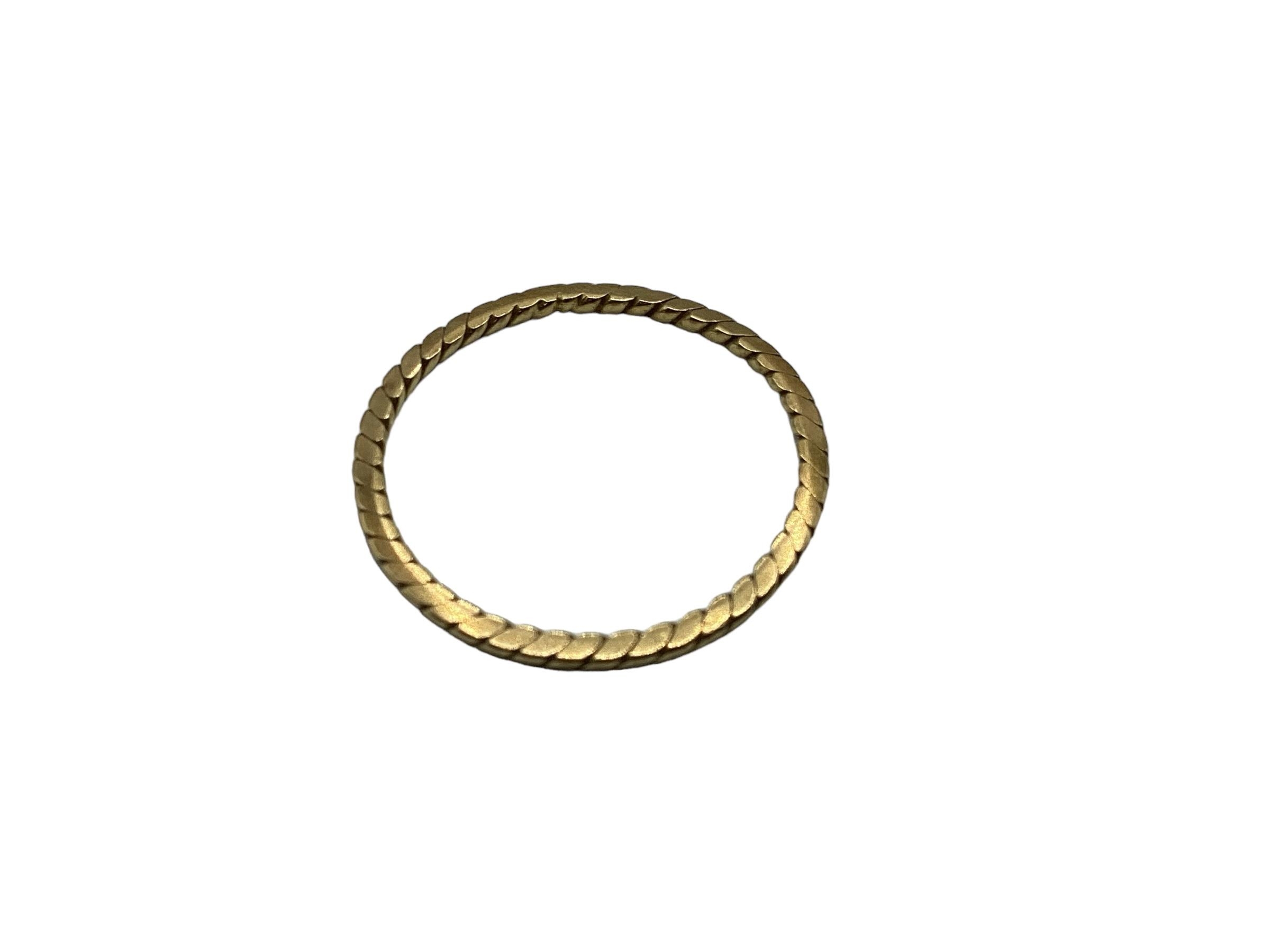 An unmarked yellow metal rope twist wedding band. Size M. 0.95g.