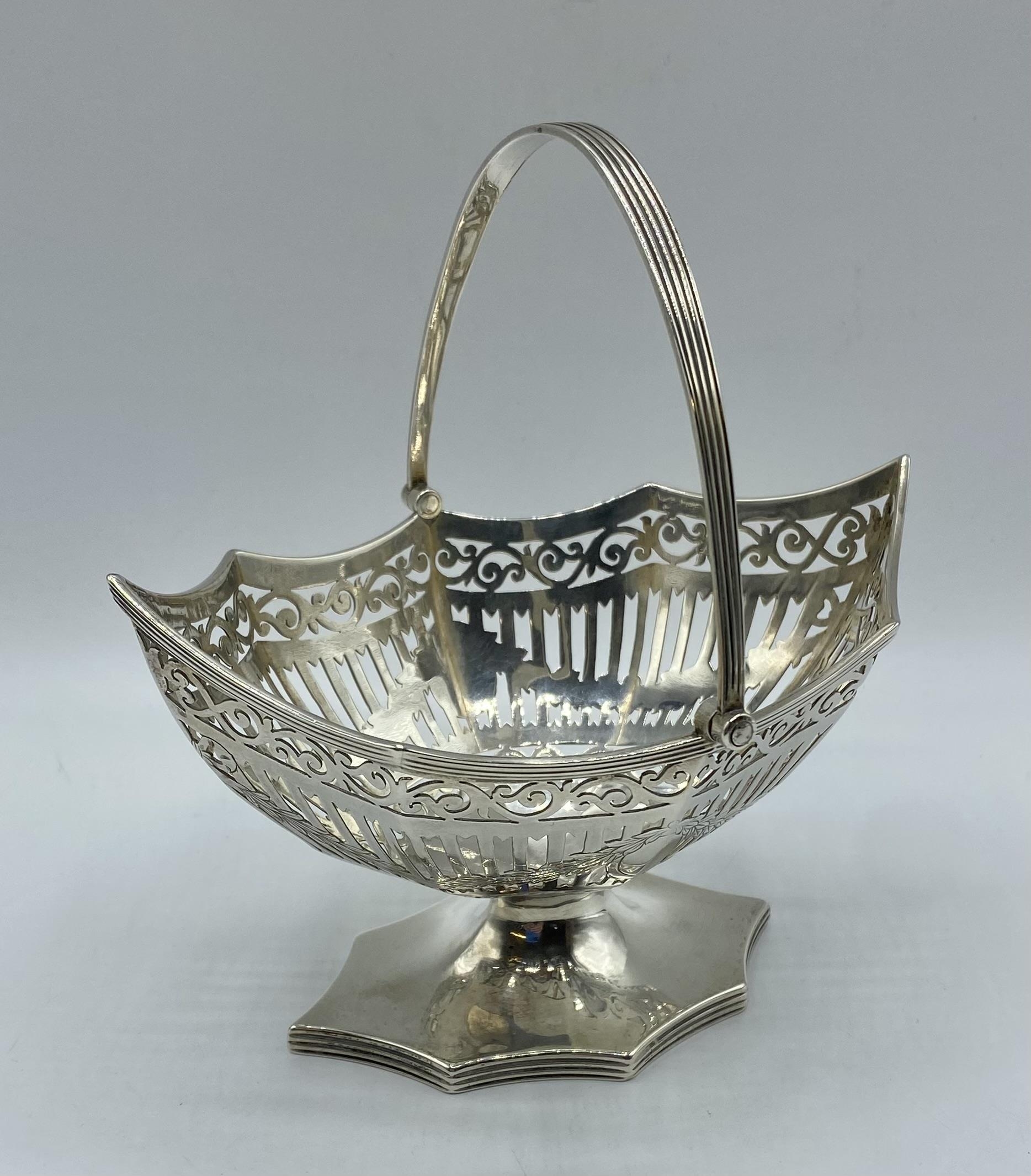 A sterling silver octagonal pierced Bonbon dish with swing handle, by Haseler and Bill, London