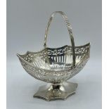 A sterling silver octagonal pierced Bonbon dish with swing handle, by Haseler and Bill, London