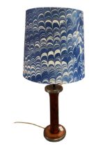 A decorative blue and white Pooky lampshade, in good condition, on a lamp base made from an old