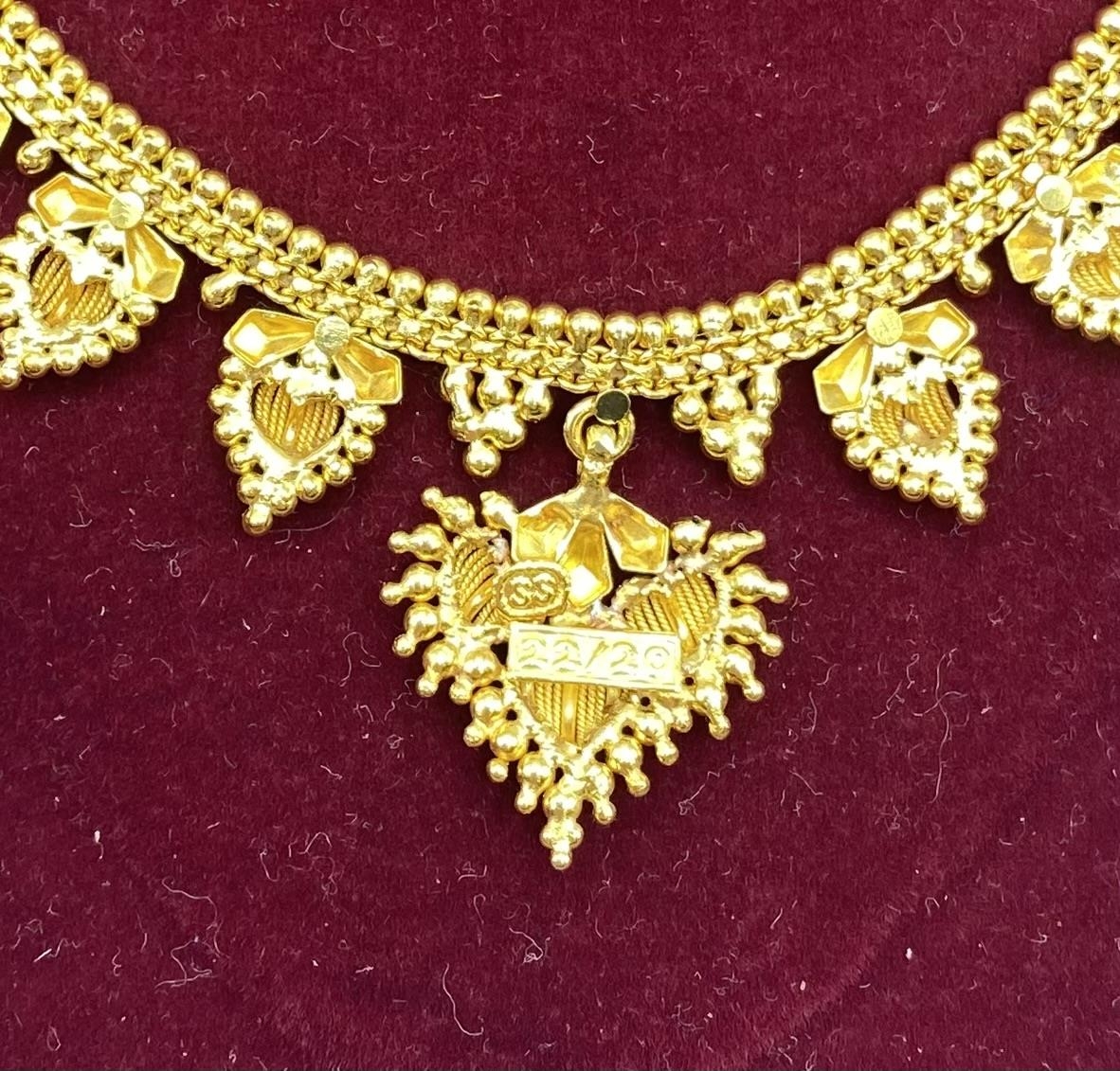 A South Asian unmarked yellow metal necklace with matching earrings marked 88. 21.6g. - Image 3 of 4
