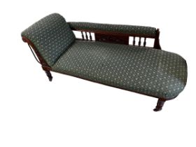 A Victorian green patterned upholstered Chaise longue raised on turned legs to castors , 181cm L