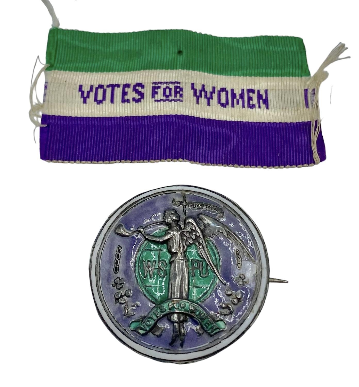 A rare suffragette 'Angel of Freedom' brooch. Circular sterling silver, green and purple enamel