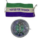 A rare suffragette 'Angel of Freedom' brooch. Circular sterling silver, green and purple enamel