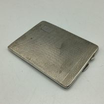 A sterling silver cigarette case with engine turned decoration and gilt interior by Joseph