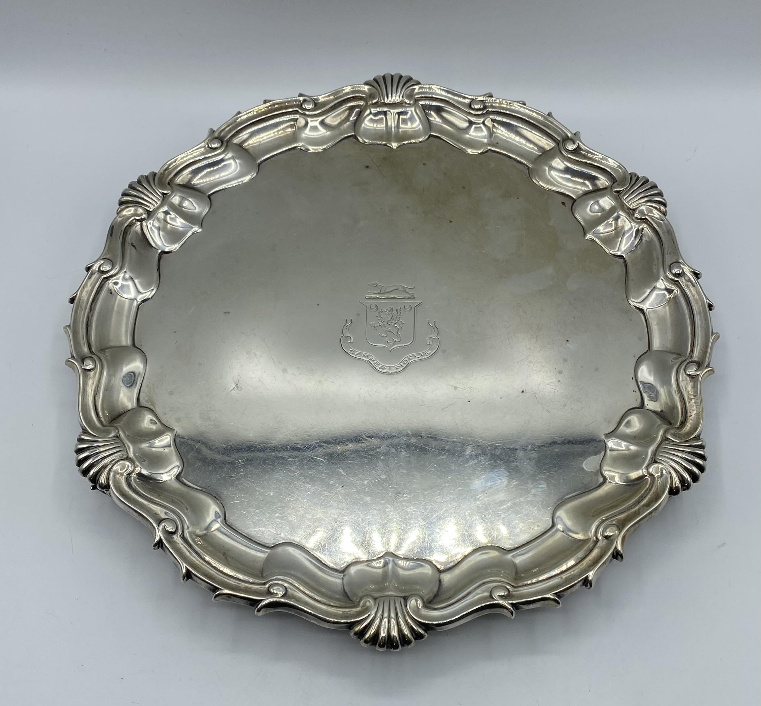 A sterling silver circular tray with central armorial 'Semper Fidelis' (always Loyal). Cast border