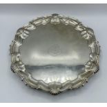 A sterling silver circular tray with central armorial 'Semper Fidelis' (always Loyal). Cast border