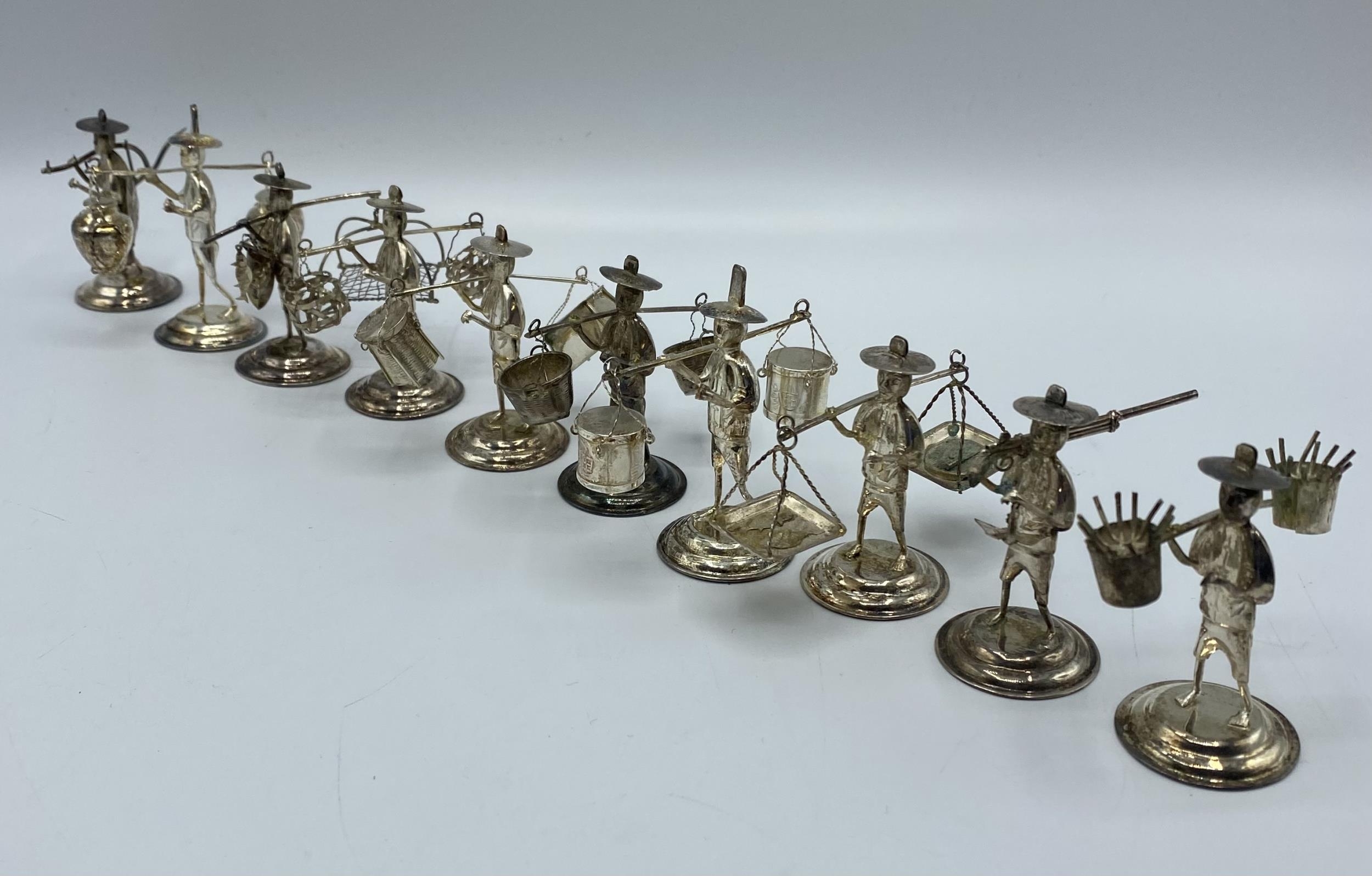 A set of 10 Hong Kong Sterling silver figures of gentlemen carrying baskets. together with a