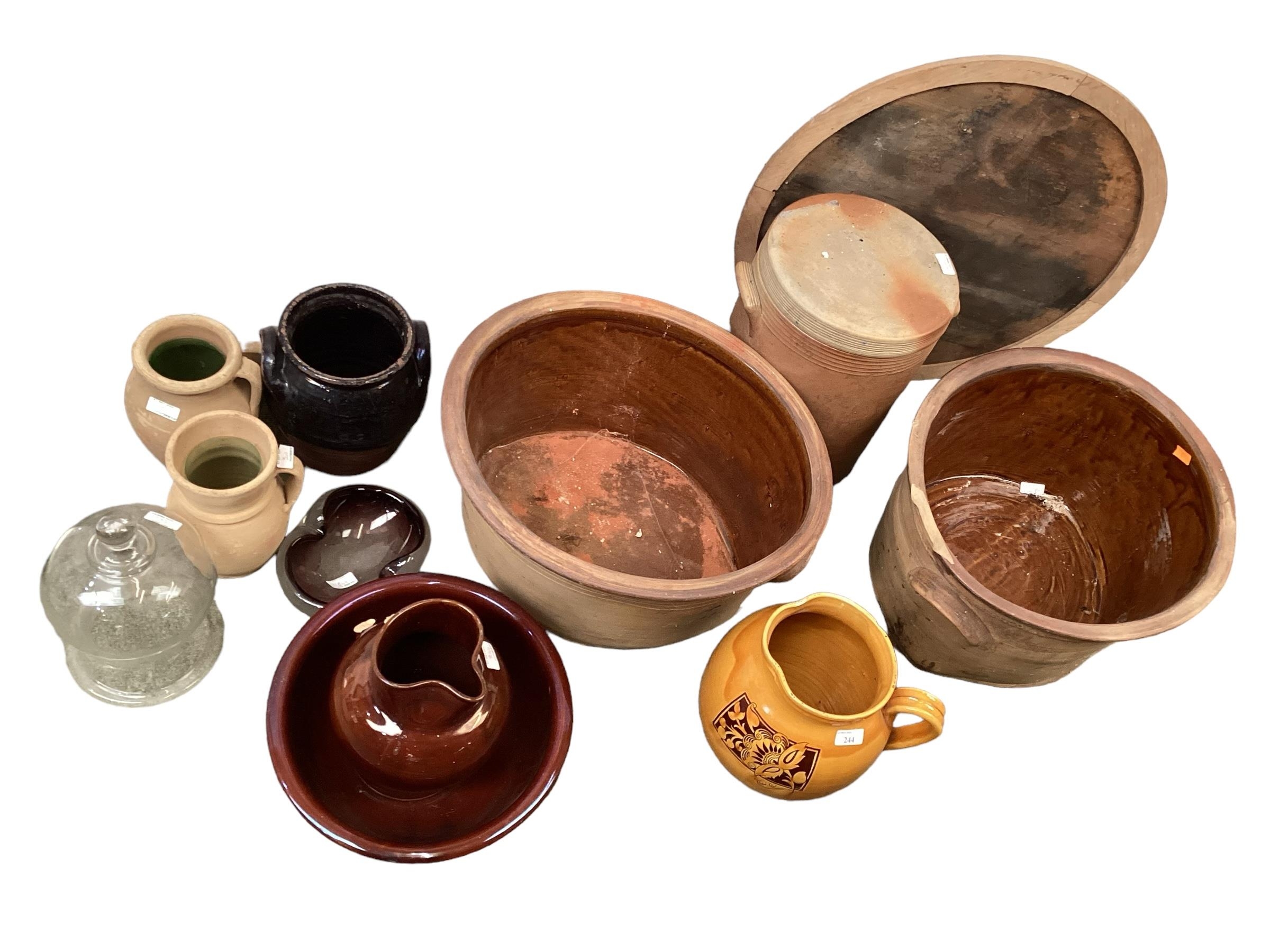 A pottery yellow ochre jug, and other earthenware vases, jugs, a lidded crock and two large bowls,