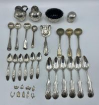 A collection of sterling silver and white metal items to include pepperettes salts cutlery etc, 265g