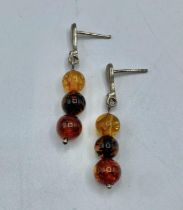 A pair of amber drop ear rings.