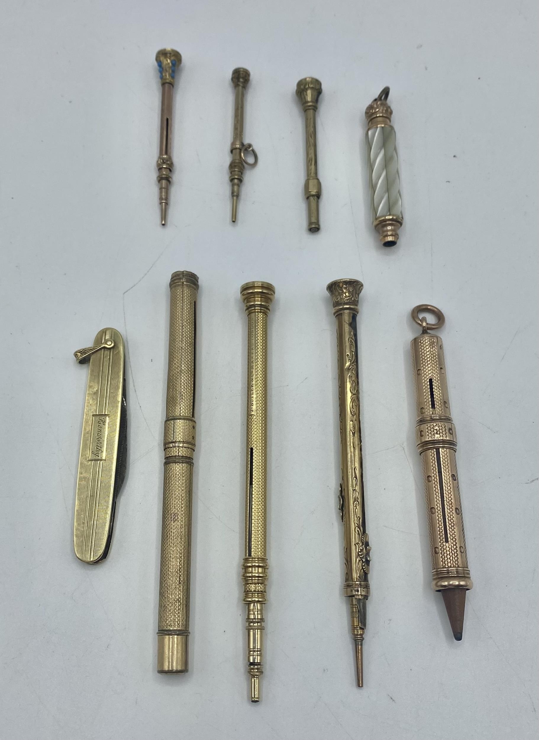 A collection of unmarked yellow metal propelling pencils, holders and pens together with a 14ct gold