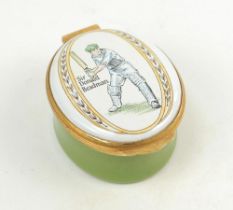 Sir Donald Bradman. Modern enamelled oval pillbox hand decorated with a portrait of Bradman standing