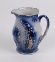 Cricket jug. Victorian Staffordshire blue glazed ceramic jug decorated in relief with a figure of