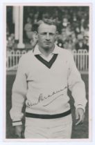 Don Bradman. Mono real photograph plain back postcard of Bradman depicted half length in cricket