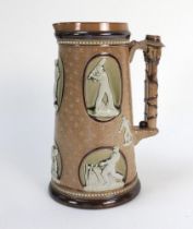 Cricketing jug. A large and impressive Doulton Lambeth stoneware tapering jug, moulded in relief