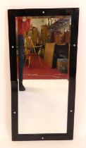 An Art Deco rectangular bevelled wall mirror, having black glass applied frame with chromed metal