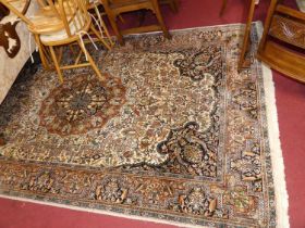 A Persian woollen Kashmir rug, with typical heavy floral decorated ground within trailing borders,