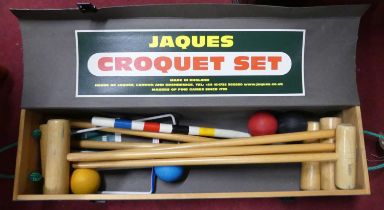A Jaques boxed croquet set Wooden box with cardboard lid. There are six hoops.