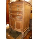 An early 20th century limed oak bowfront fitted cutlery chest, having four long graduated drawers