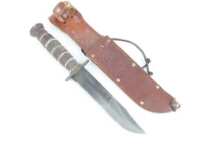 A Ka-Bar USMC fighting knife, having a 17.5cm blade marked CAMILLUS N.Y and USMC to the opposing