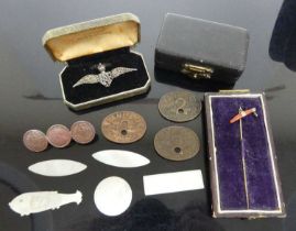 A brooch fashioned from three Indian silver rupees; together with a mother of pearl counter;
