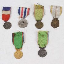 A World War Two French war medal naming O. Philis and dated 1942, on tricolour ribbon; together with