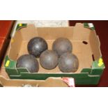 Five antique iron cannon balls of various sizes, largest 10cm dia.