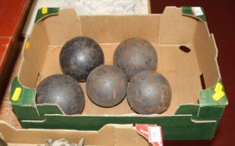 Five antique iron cannon balls of various sizes, largest 10cm dia.