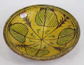 A 19th century Afghan green and yellow slip-glazed pottery bowl, dia.32cm