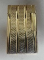 S.T. Dupont of Paris - a gilt metal pocket cigarette lighter, having all-over engine turned